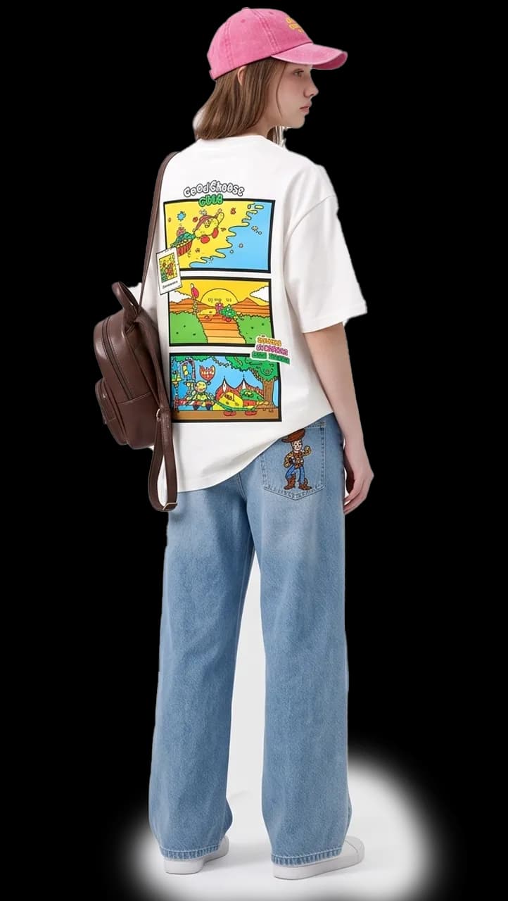 Model wearing the Giggle Crumble comic-print tee with a mini backpack